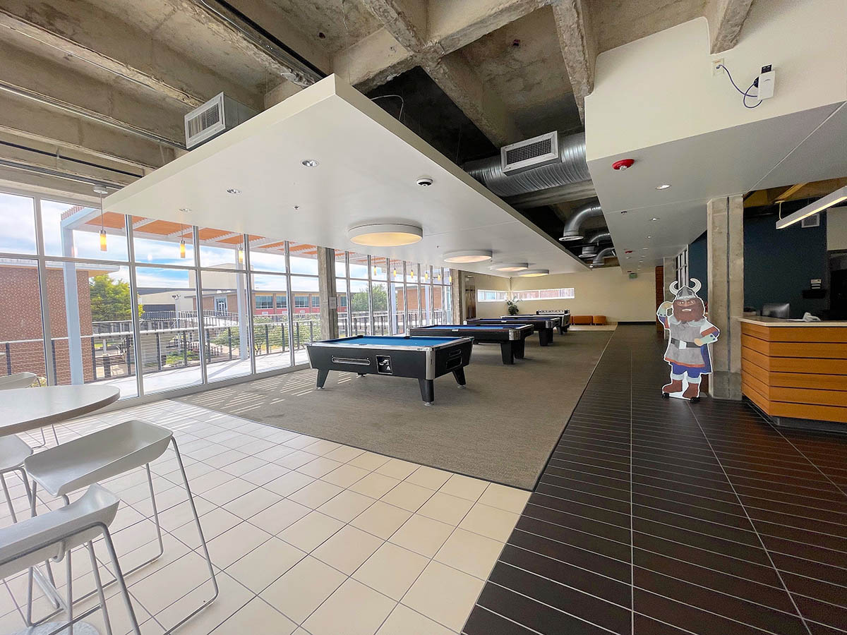 Main room of student life center featuring billiards tables