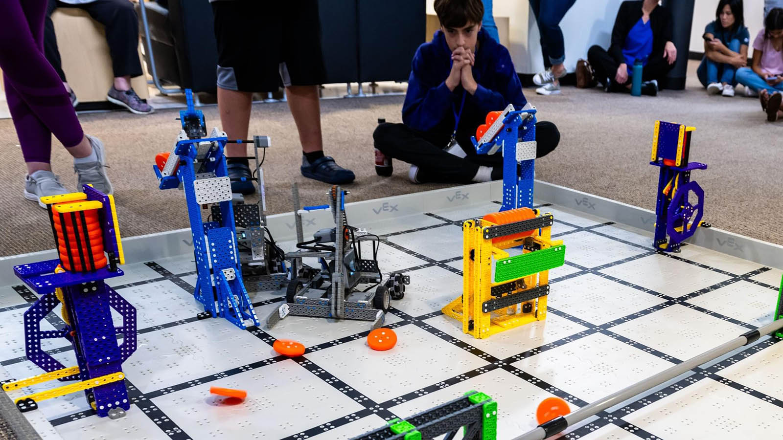 Camper looks on at robots on display on floor