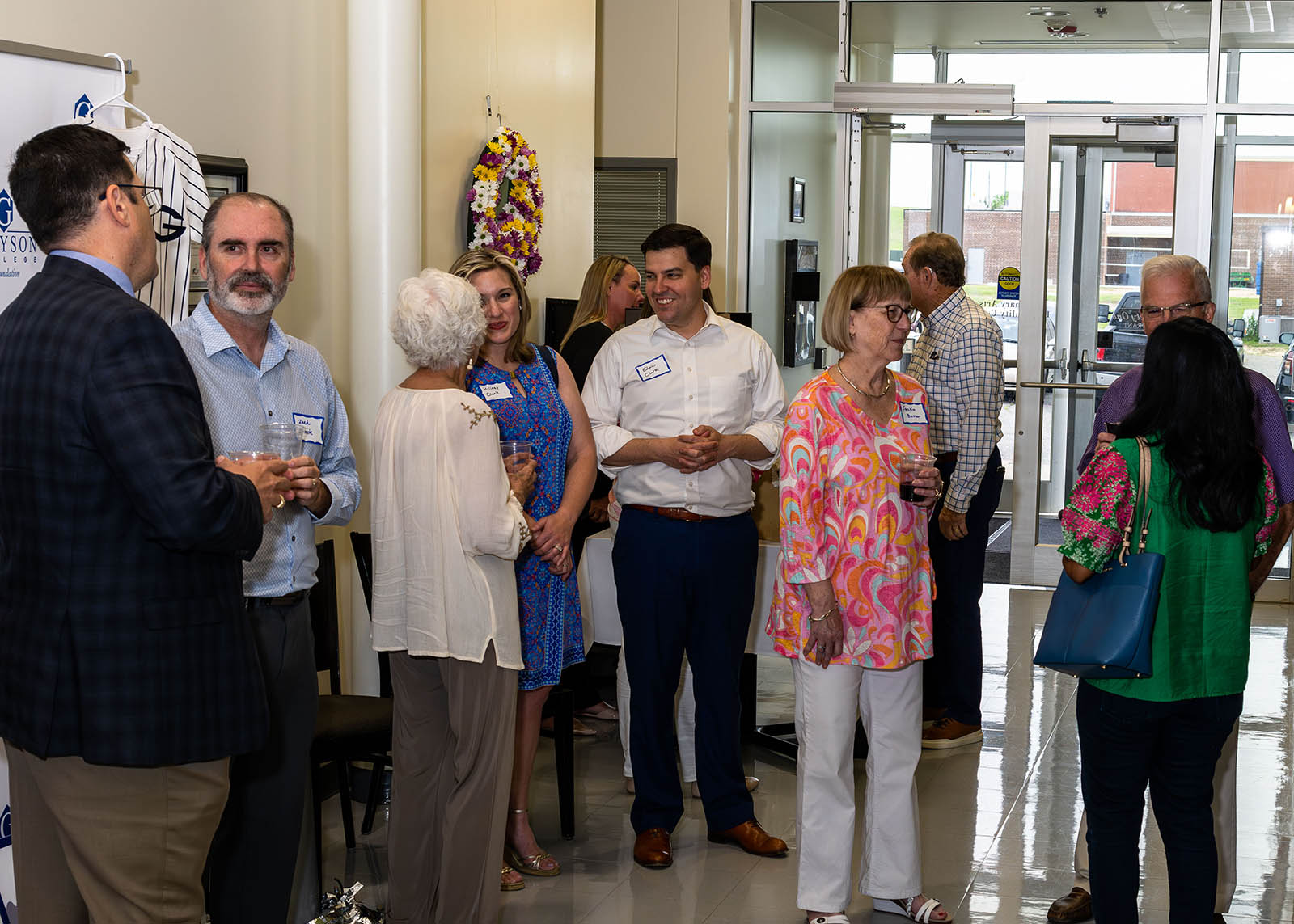 Crowd gathered around entranceway socializing