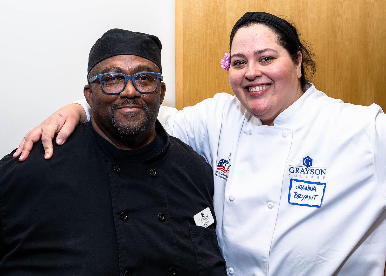 Chef and worker posing for photograph