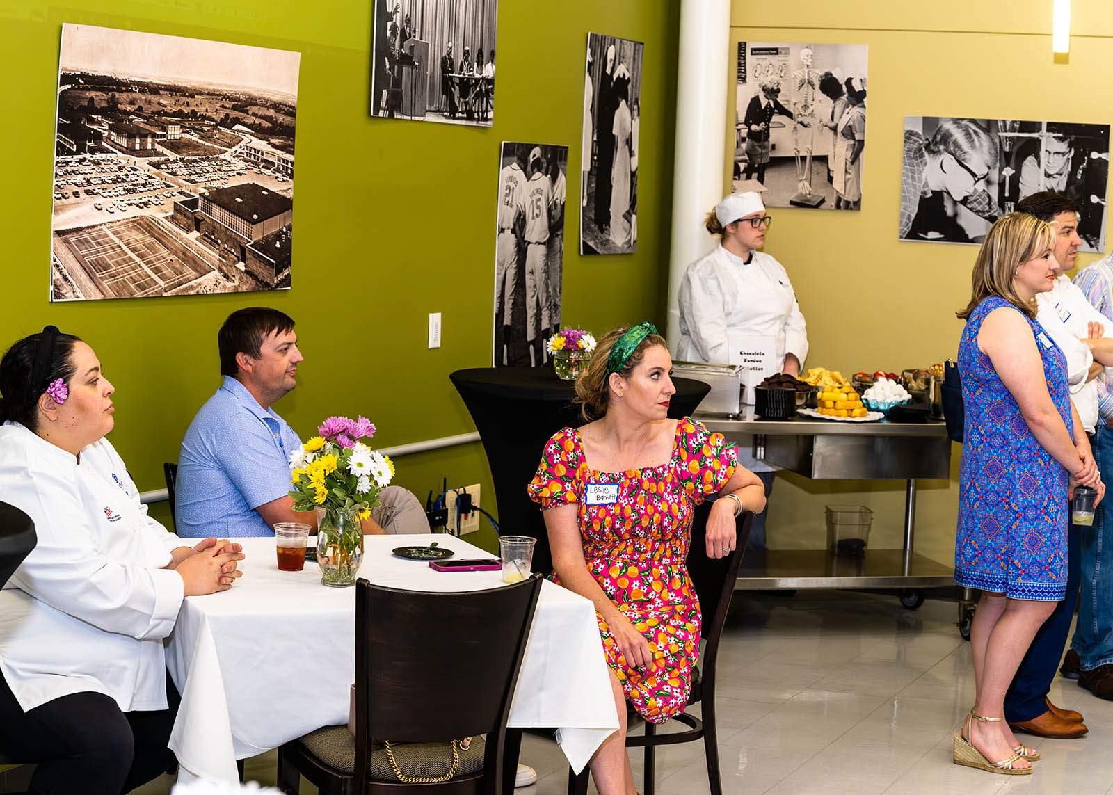 Guests listening to presentation seated at tables