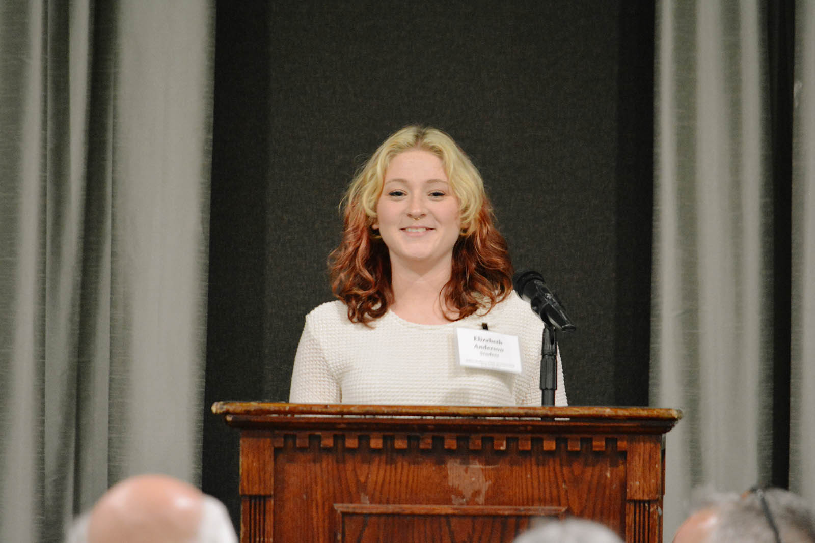 Woman speaking in front of podium