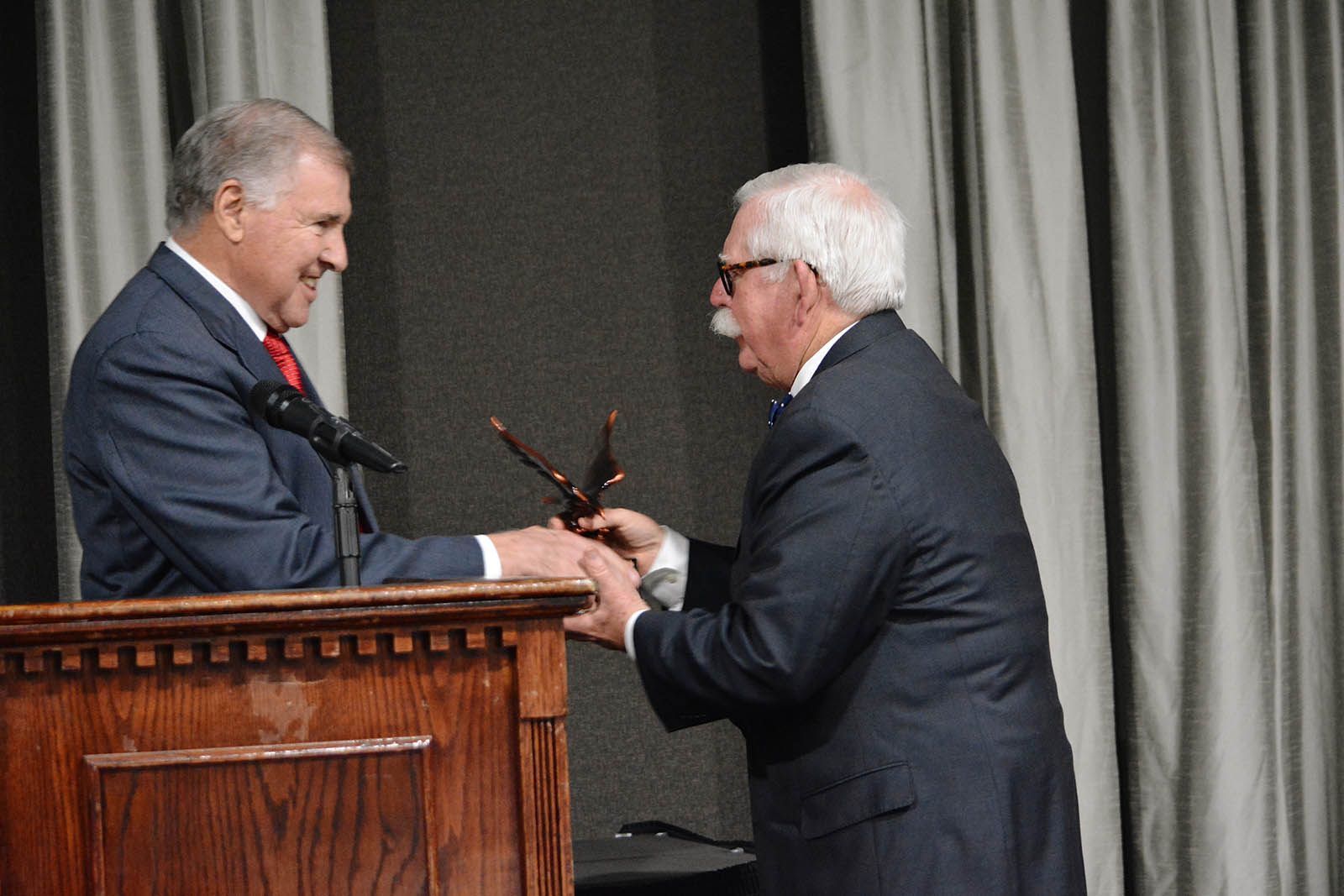 Man shaking hands with presenter at podium