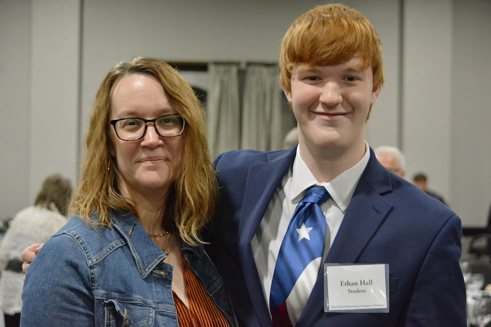 Man in suit with woman posing for photograph