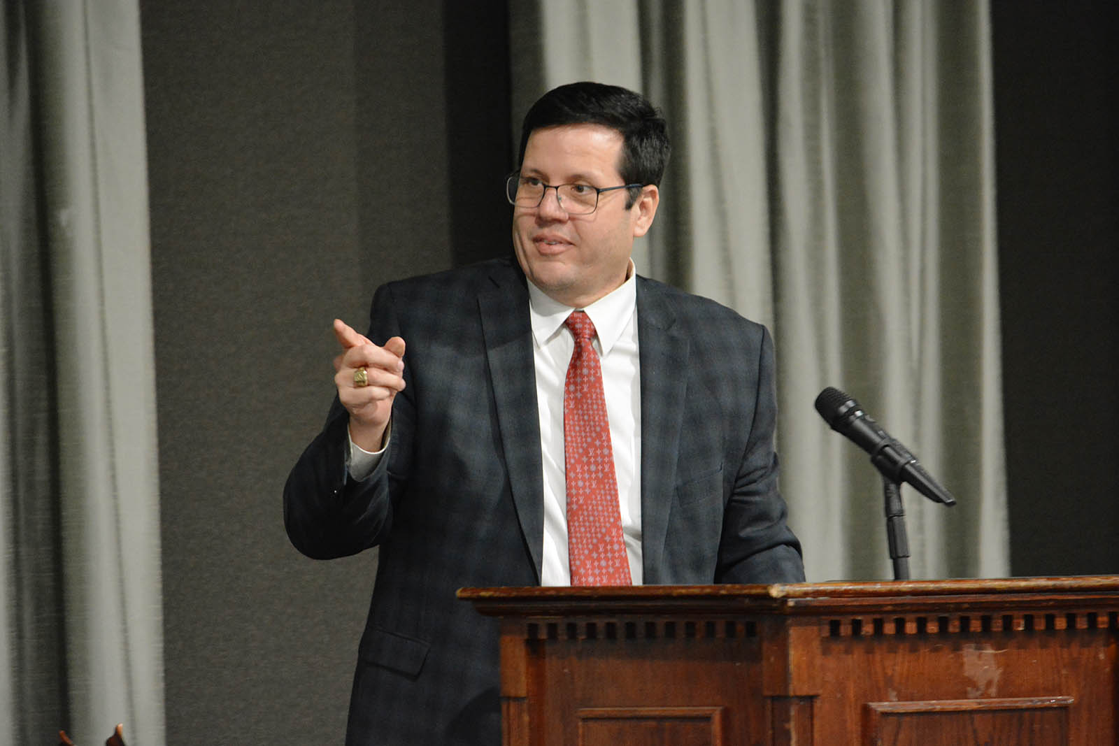 Man pointing into audience at podium