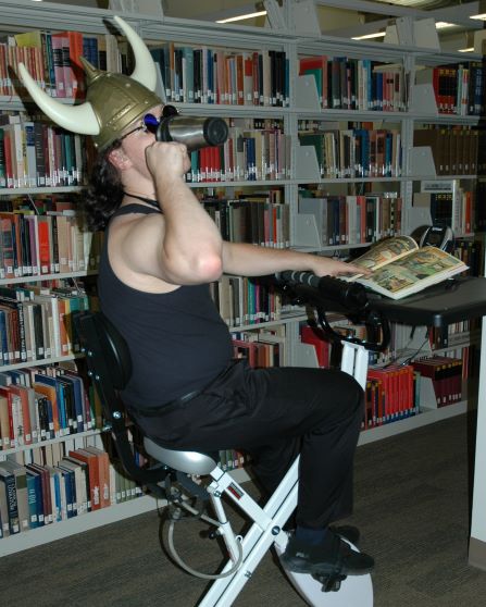 Student seated on desk-bike furniture