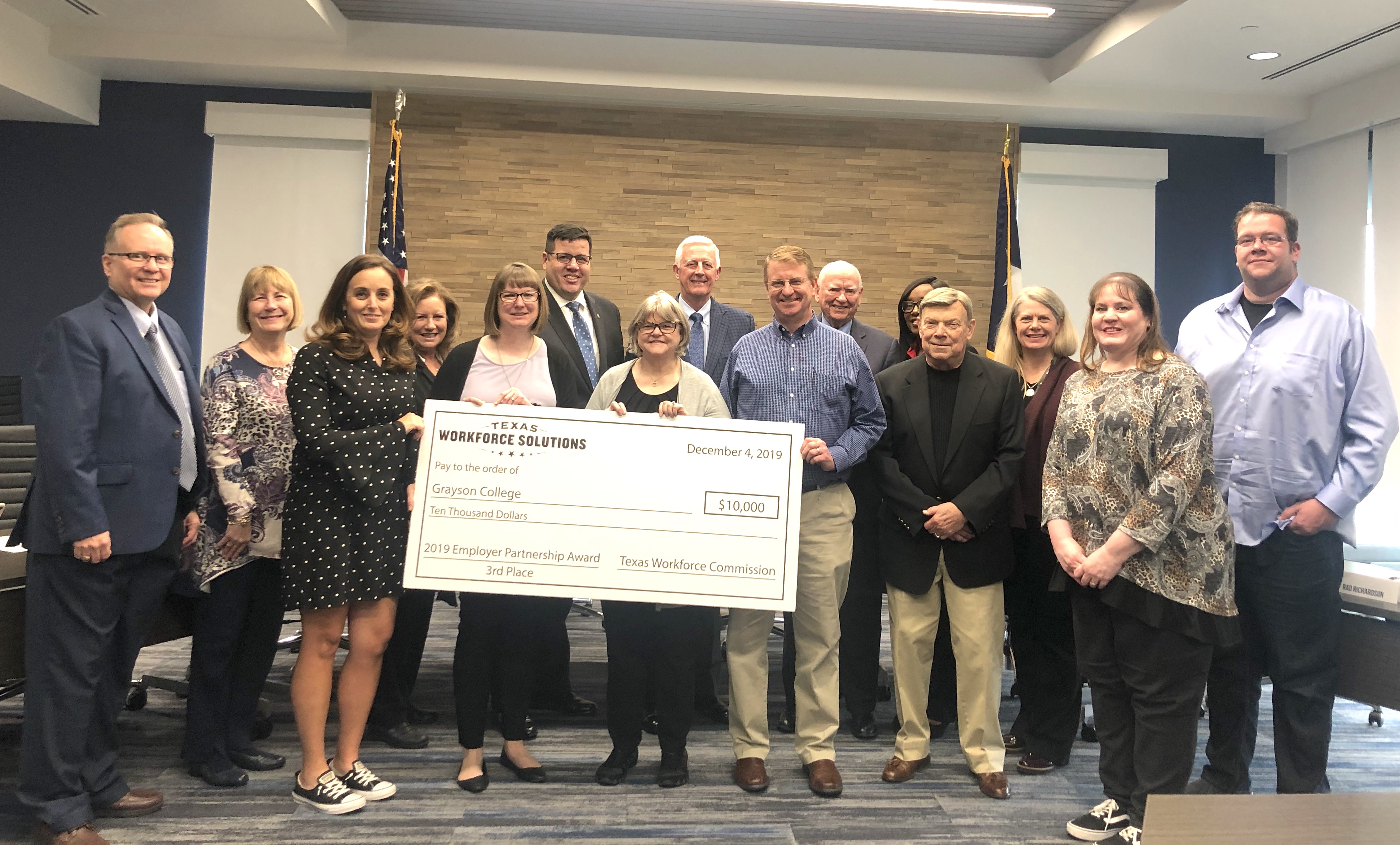 Grayson College Board of Trustees and Adult Literacy Program holding up 10,000 dollar check