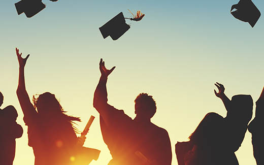 Student Silhouettes throwing graduation Caps