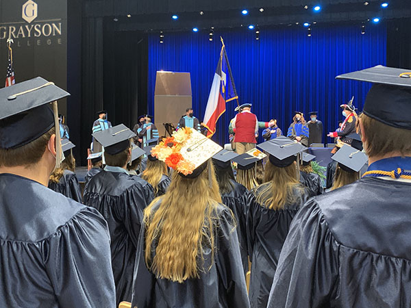 Students in audience, looking towards stage during ceremony