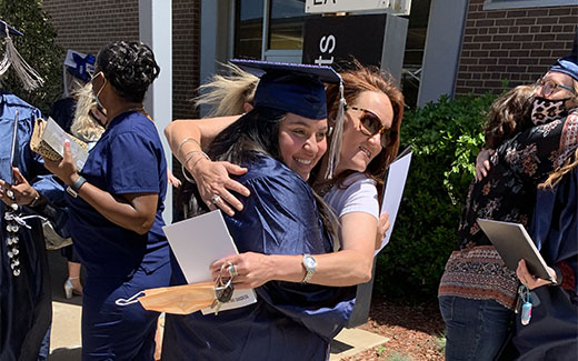 Student Celebrating commencement with a hug