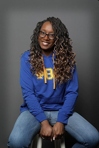 Lavada Burse seated on stool