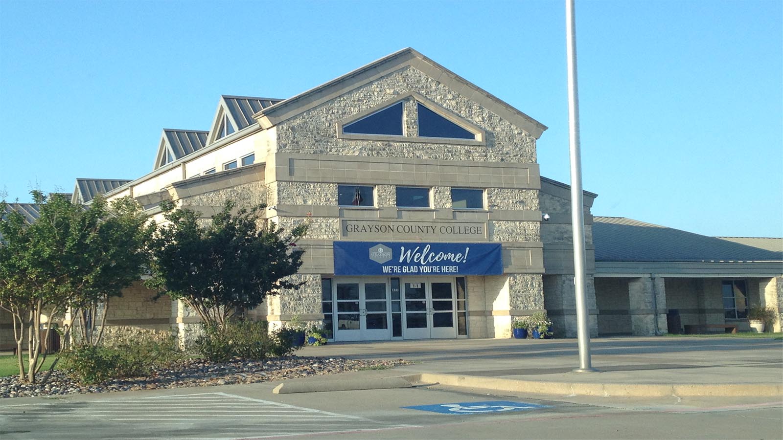 Academic Building with banner reading Welcome, We're Glad You're Here