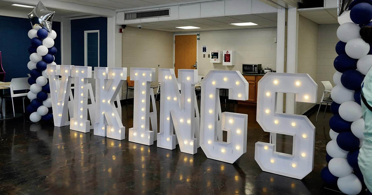 Large illuminated block letters spelling Viking inside room