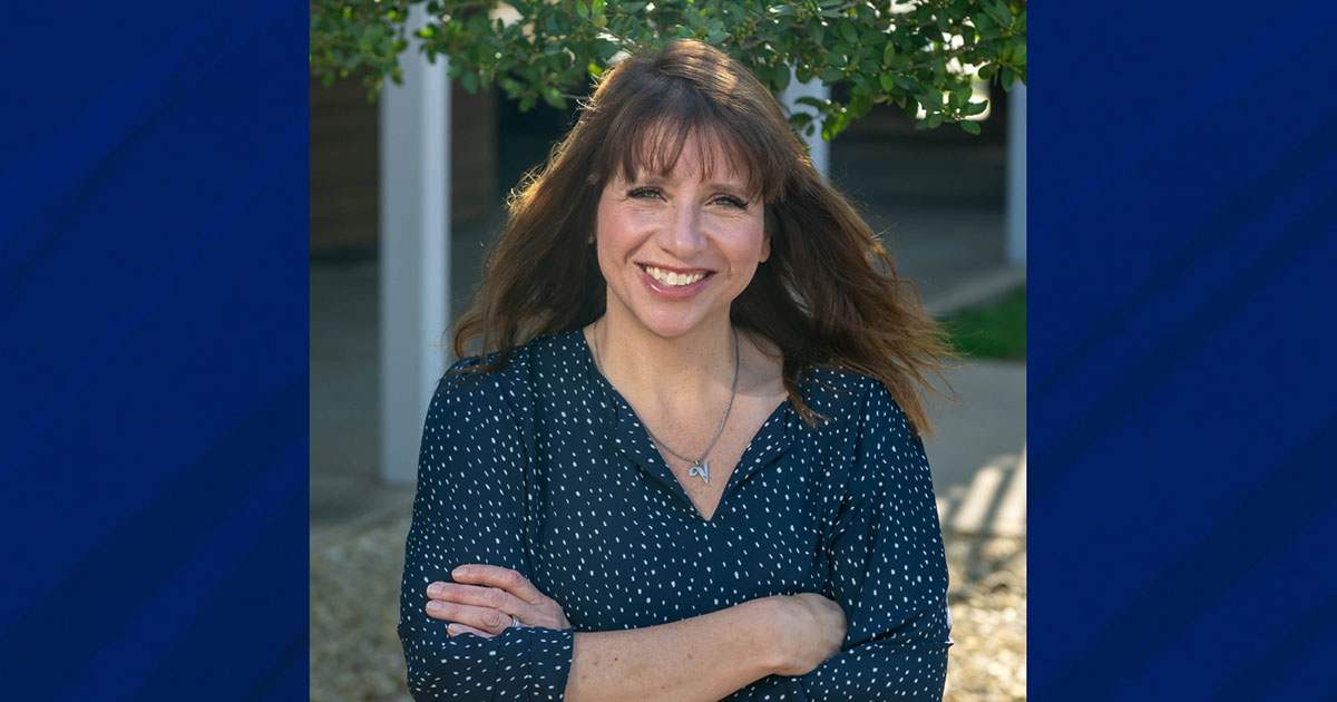 Robyn Voight standing outside in front of academic building