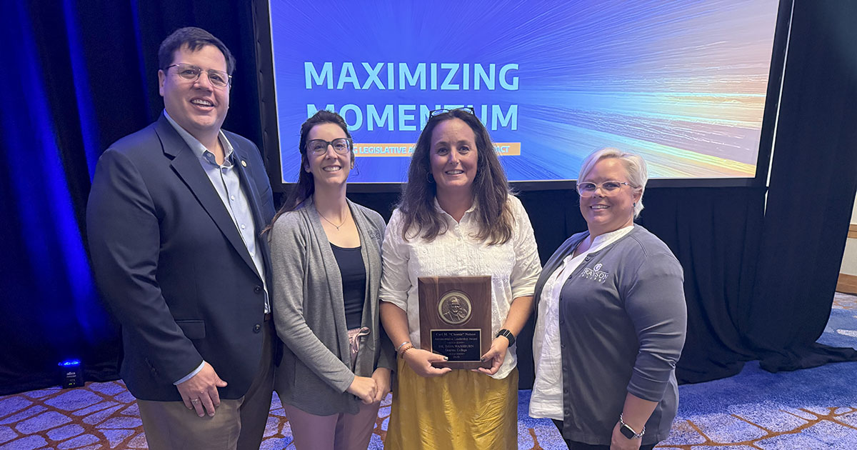 Dr. Dava Washburn holding her award surrounded by Grayson College Staff