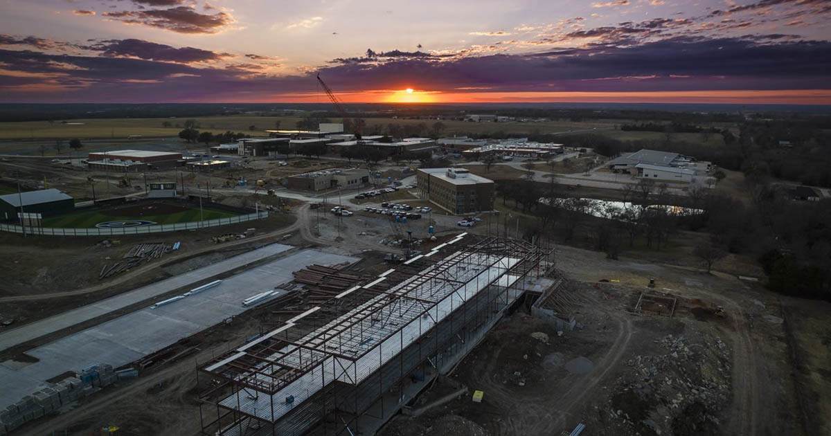 Drone view of construction on campus by sunset
