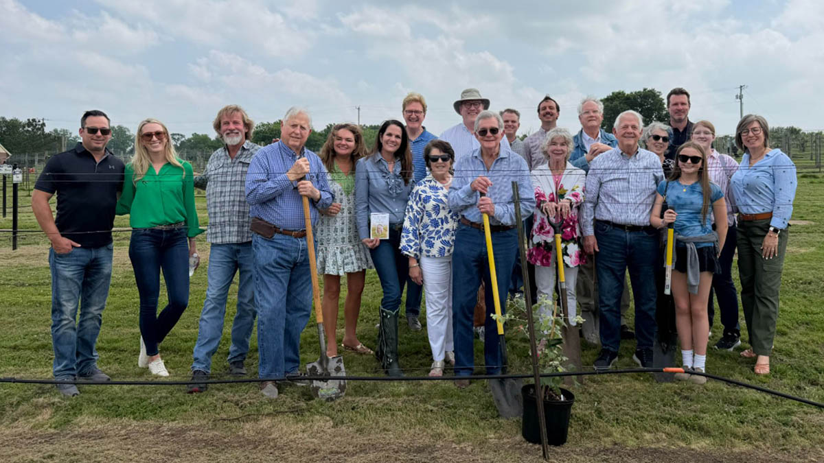 Approximately 20 Munson Family members assisting in planting a vine at the grayson college vineard