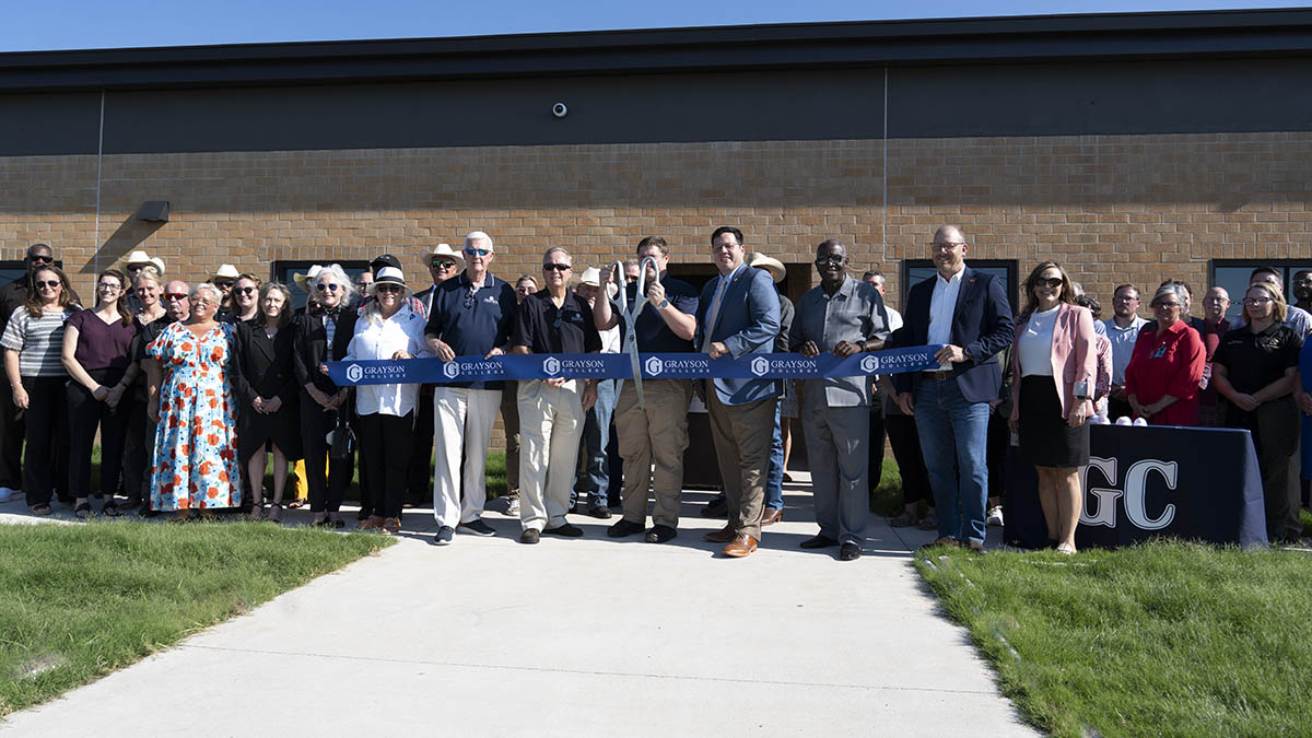 Grayson College administration and staff performing a ribbon cutting