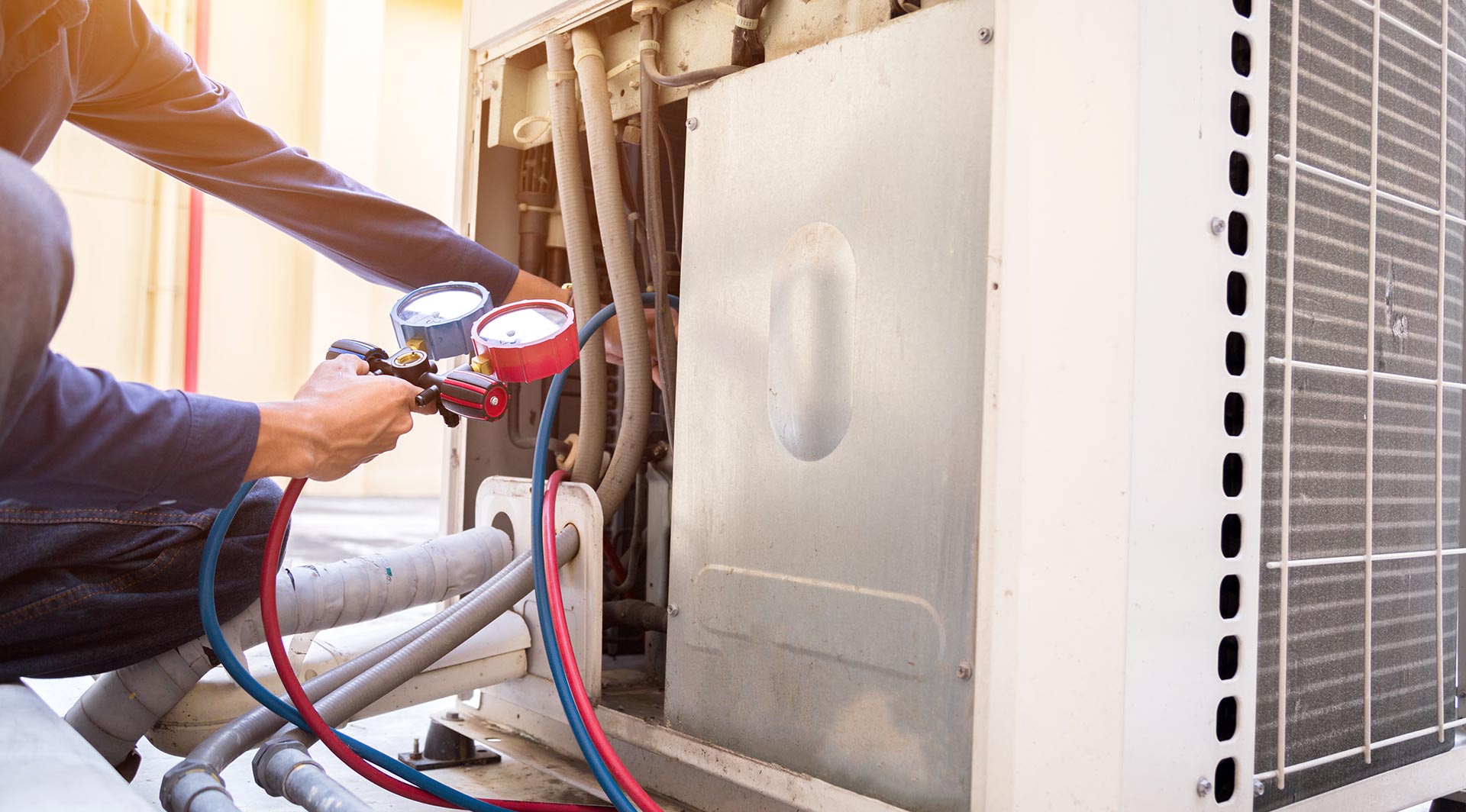 Mechanic maintaining an air conditioning compressor 